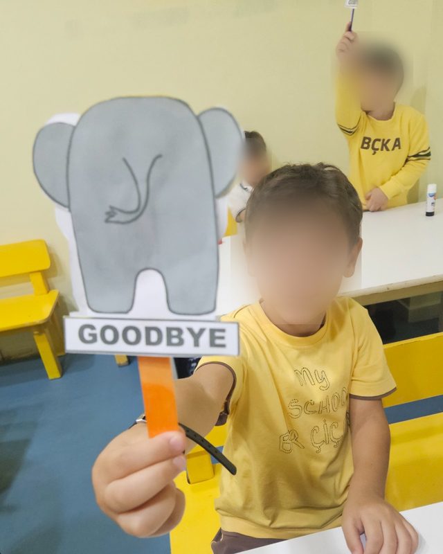 Goodbye yazan fil kartıyla bir çocuk